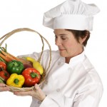 Chef looking at a basket of fruit and vegitables